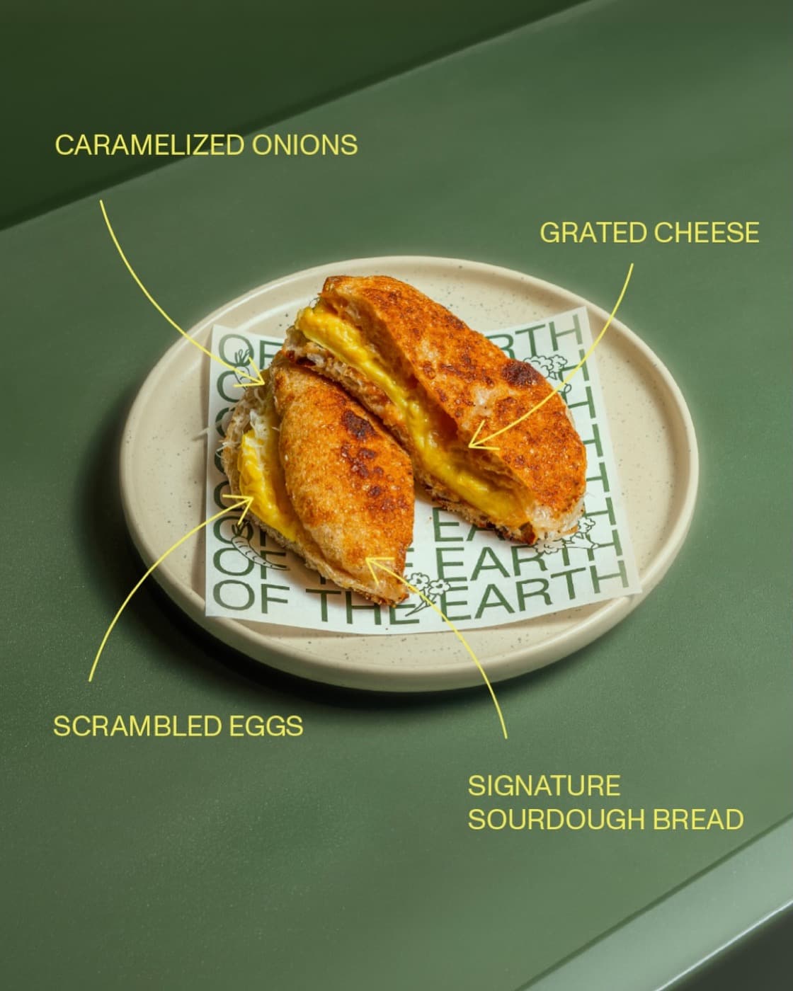 Scrambled egg sandwich on signature sourdough with grated cheese and caramelized onions