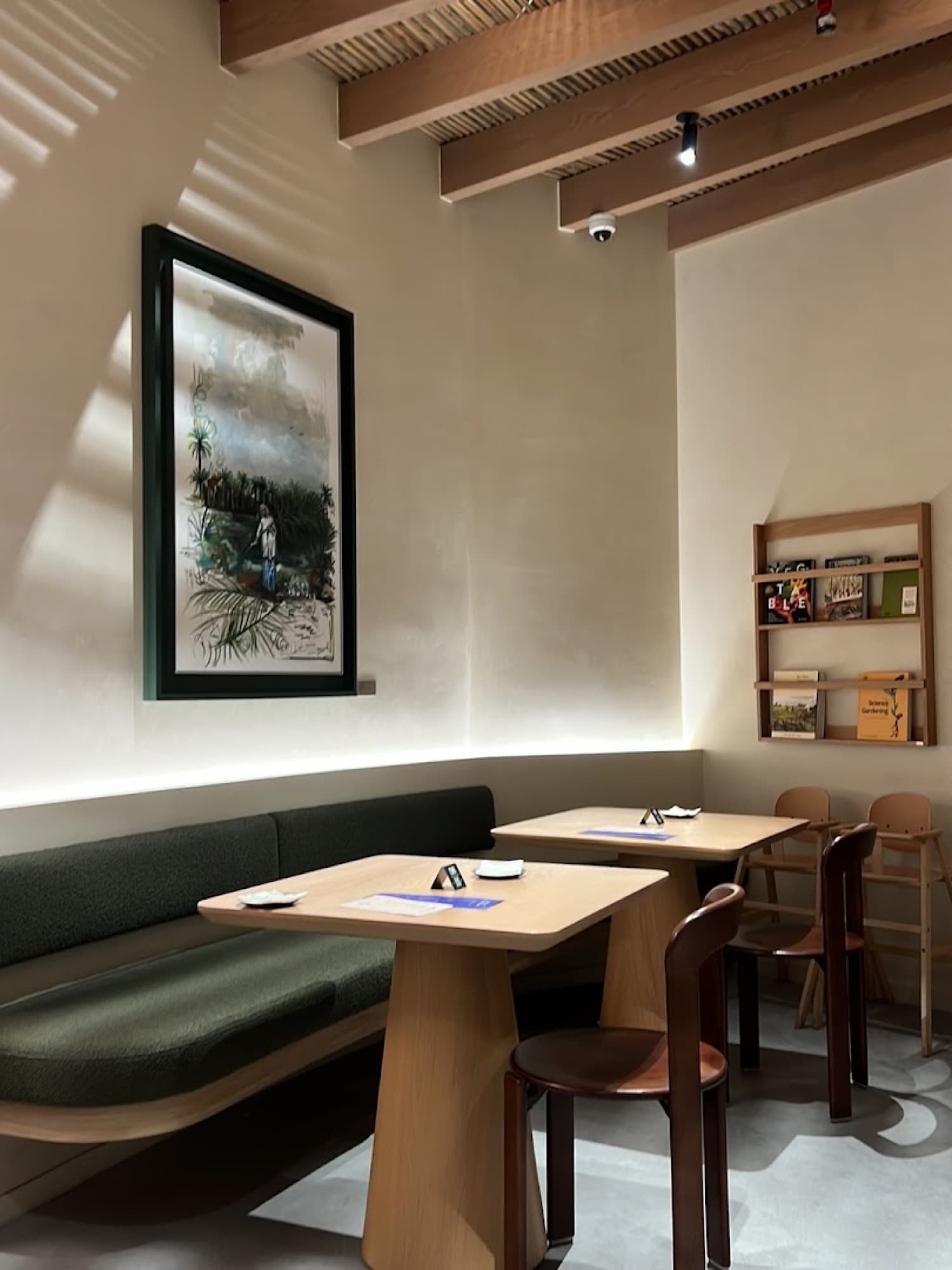 A quiet corner with framed botanical art and warm plaster walls